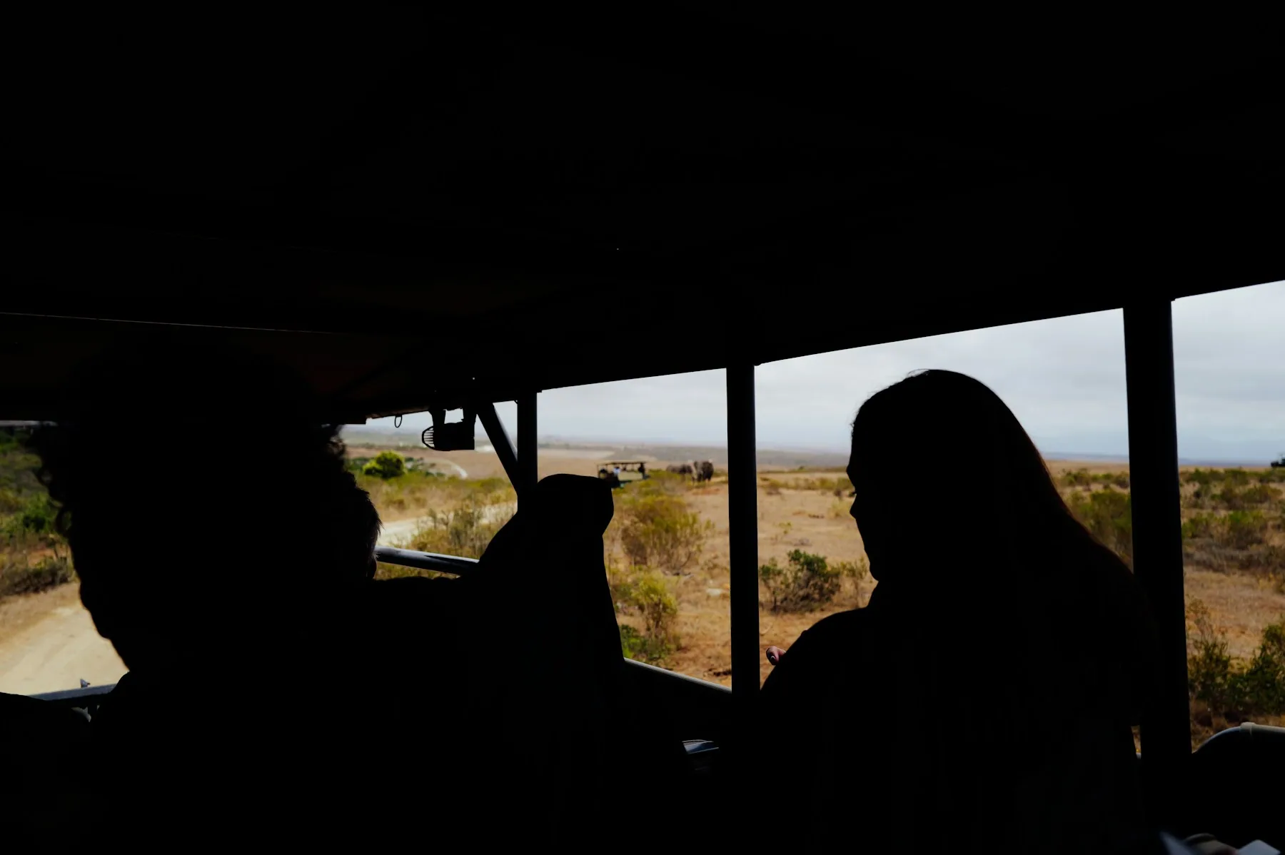 Safari vehicle in a wide East African landscape